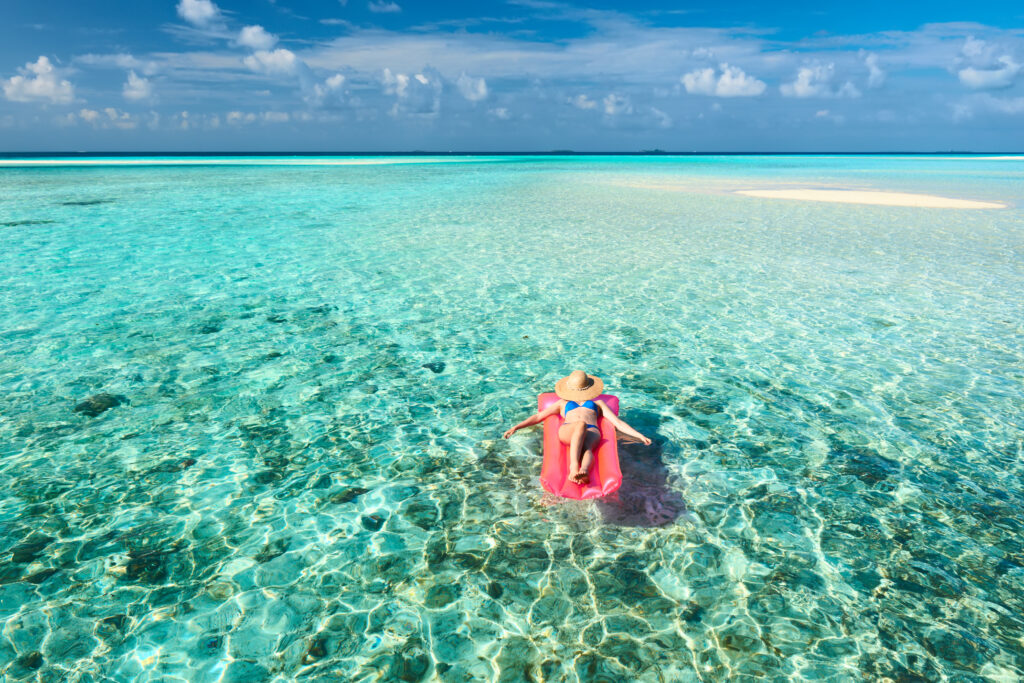 women relaxing in maldives. booked all inclusive vacations.